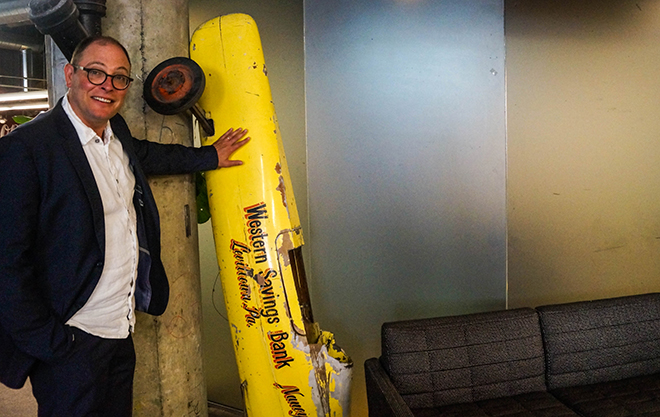 Freundlich next to a relic he brought all the way from his New York City apartment. Photo by Nathan Allen